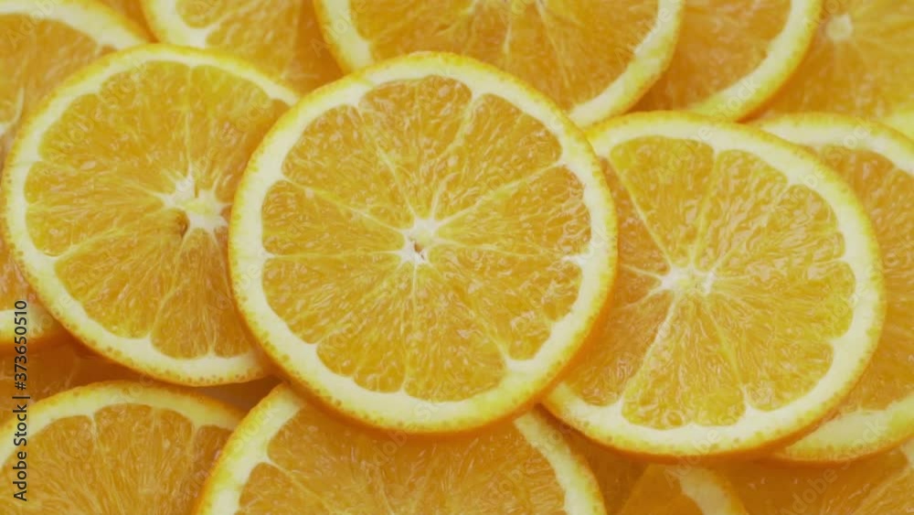 Macro Round Fresh Juicy Slices Of  Citrus Orange, Rotate, Top View. Pieces of Orange Fruit Isolated, Close-up. The Concept Of Healthy Vegetarian Food and Vegan Vitamin C Diet.