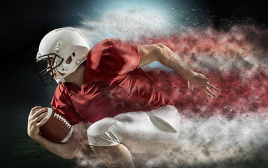 American football sportsman player with ball in action on stadium under lights of background. Sport, proud footballer in white helmet and red t-shirt ready to play.