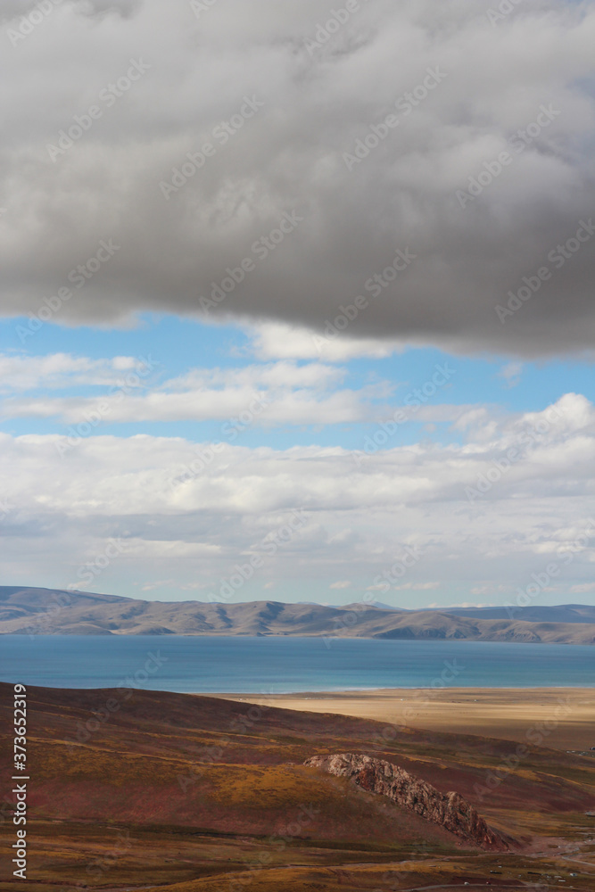 View of mountains and Namtso Lake with the dramatic sky in Tibet, China View of mountains and Namtso Lake with the dramatic sky in Tibet, China