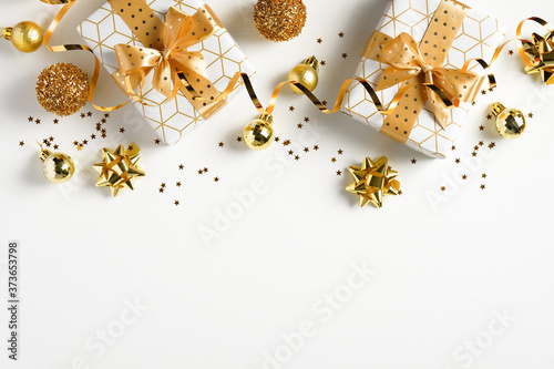 Christmas flat lay composition with luxury gift boxes, golden balls, Xmas decorations on white background. Christmas, New Year, winter holidays concept.