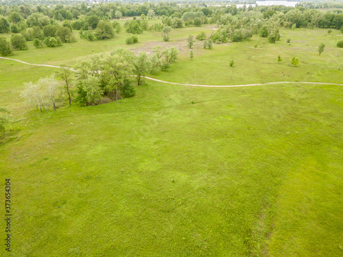 Aerial drone view. Green meadow in spring.