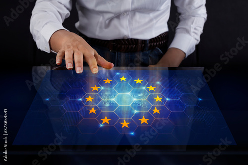 Business woman touching screen with European union flag