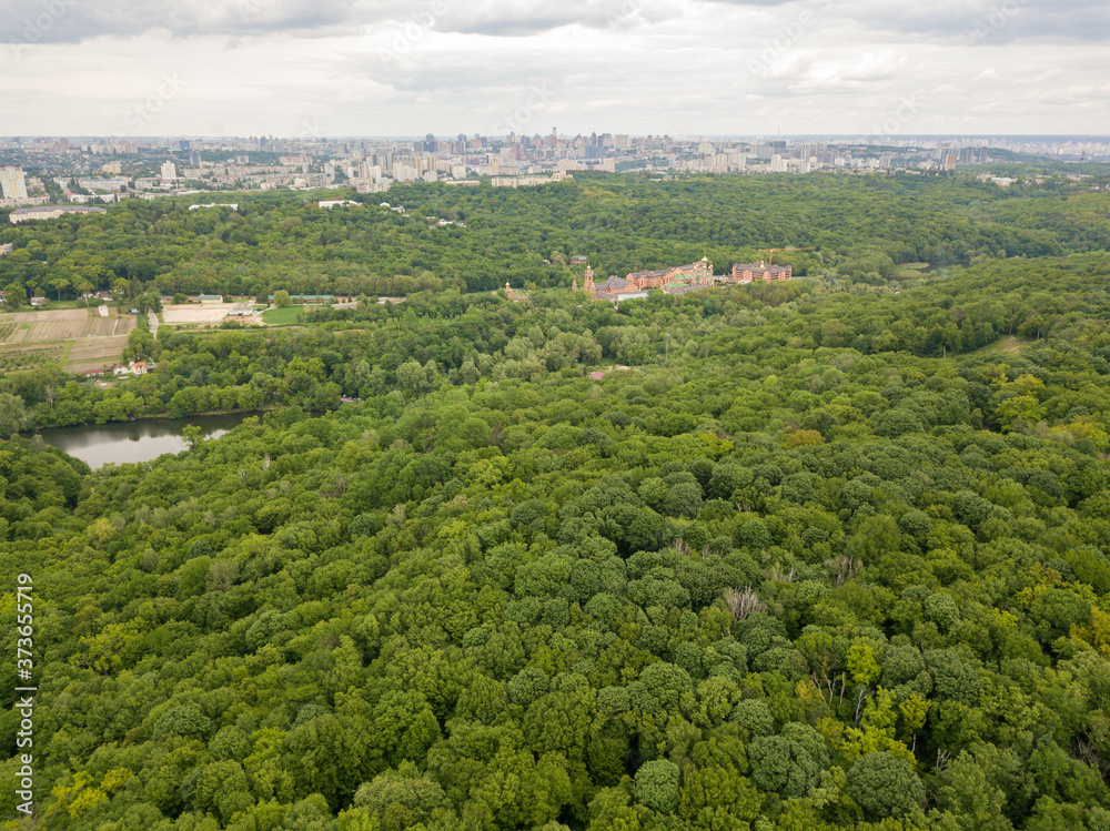 Fototapeta premium Aerial drone view. Buildings in the forest in Kiev.
