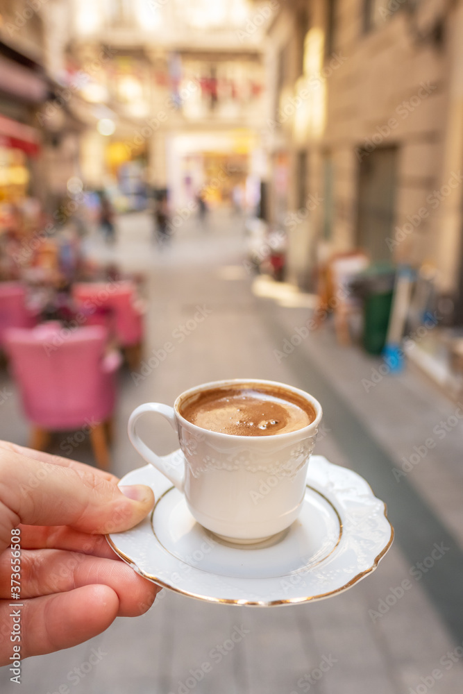 Mens hand holding cup of the traditional Turkish coffee close-up in Istanbul Mens hand holding cup of the traditional Turkish coffee close-up in Istanbul