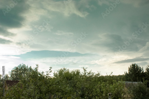 Summer landscape with clouds illuminated by the evening sun.