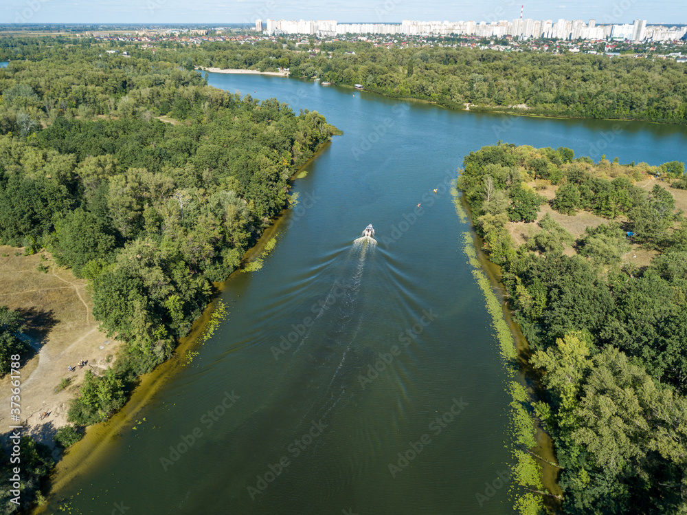 Fototapeta premium Motor boat in the Dnipro river. Sunny clear summer day. Aerial drone view.
