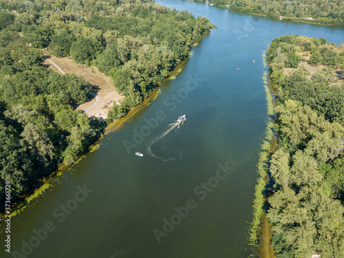 Motor boat in the Dnipro river. Sunny clear summer day. Aerial drone view.