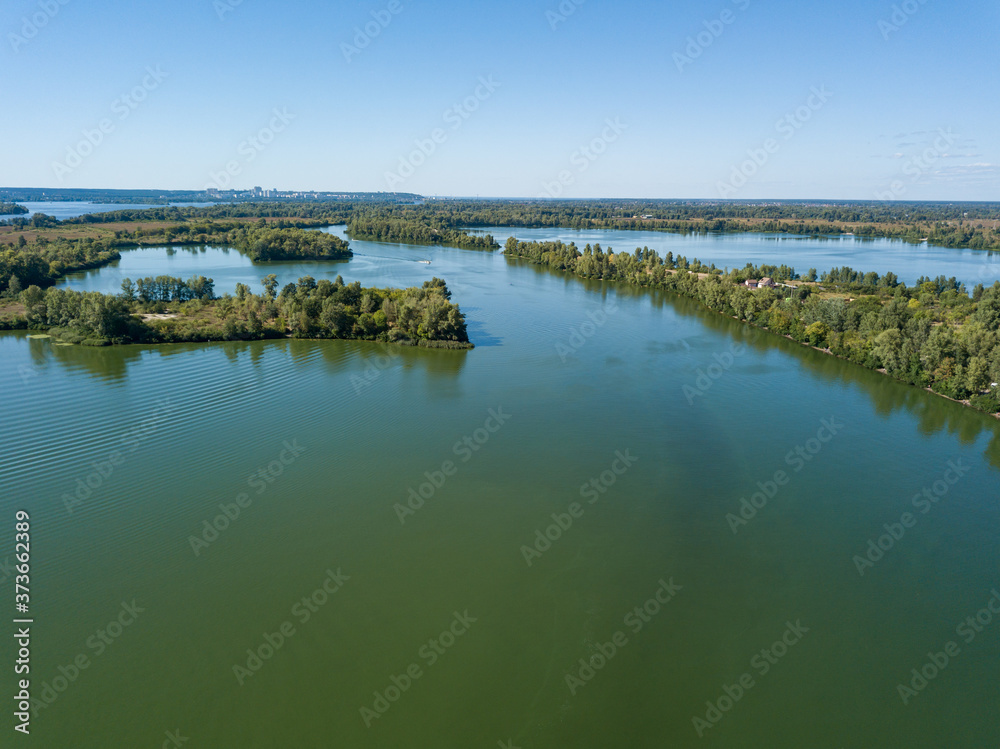 Panoramic view of the Dnieper river in Kiev. Sunny clear day. Aerial drone view.