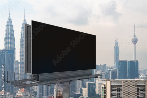 Canvas Print Blank black road billboard with Kuala Lumpur cityscape background at day time