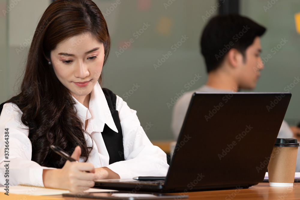 Business asian woman working and note job in paper in office. Business asian woman working and note job in paper in office.