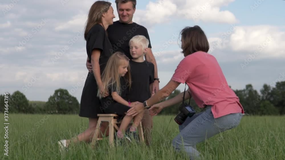 Happy family with children at a family photo shoot in the field in the summer. PAPA, mother and young beautiful children make a family portrait. Happy family with children at a family photo shoot in the field in the summer. PAPA, mother and young beautiful children make a family portrait.