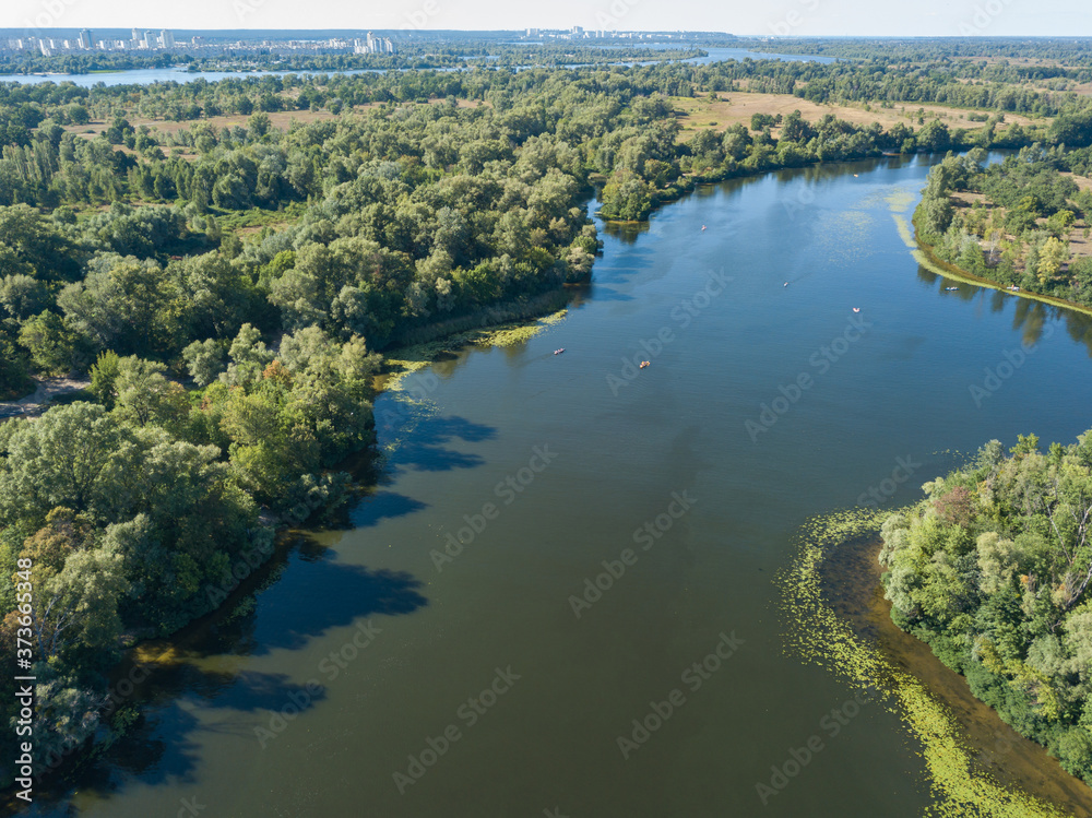 Fototapeta Green bank of the Dnieper river on a summer sunny day. Aerial drone view.