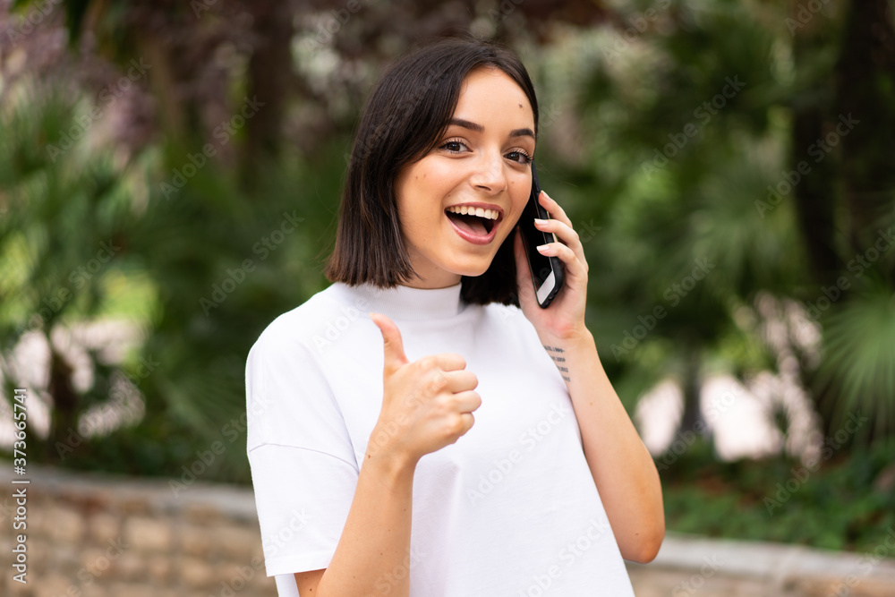 Young caucasian woman using a phone at outdoors Young caucasian woman using a phone at outdoors