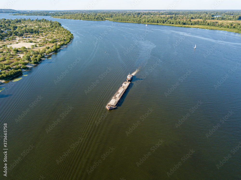 Aerial drone view. The barge sails along the Dnieper River.