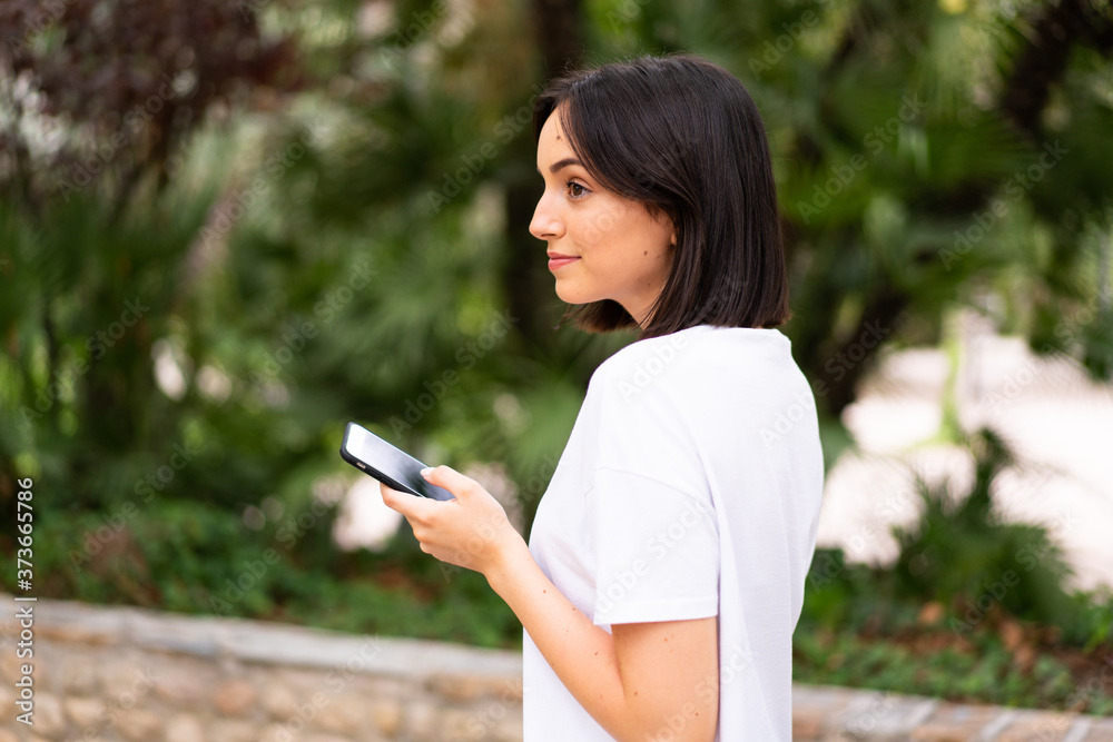 Young caucasian woman using a phone at outdoors Young caucasian woman using a phone at outdoors