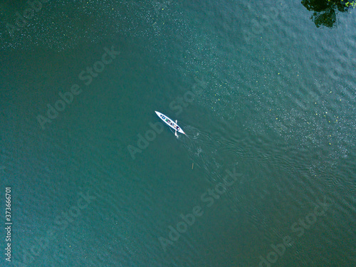 Kayak boat in the green water of the Dnieper river. Aerial drone view.