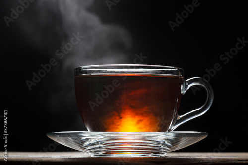 Cup of hot English tea on a black background. close up