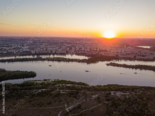 Aerial drone view. Sunset over the Dnieper River and the city of Kiev. © Sergey