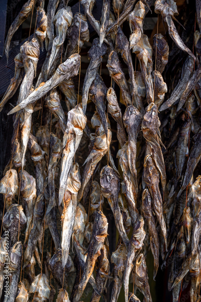 Bundles of dried salted goby or bullhead fish for sale at outdoors seafood market
