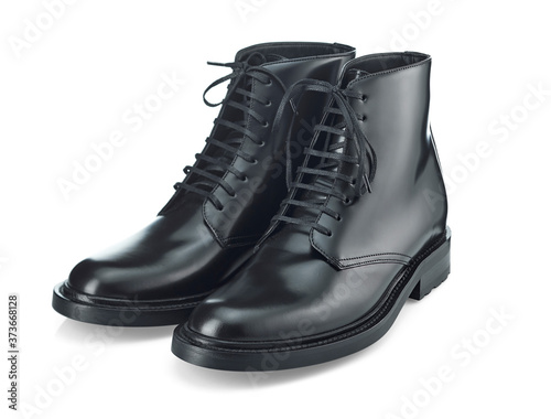 Classic black plain toe boots made of durable glossy leather with a small lace-up heel, isolated on a white background with a shadow. Top view at an angle.