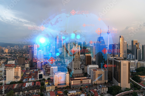 Photography Glowing hologram of Earth planet map on aerial panoramic cityscape of Kuala Lumpur at sunset, Malaysia, Asia