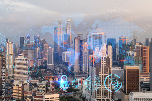 Canvas Print Glowing hologram of Earth planet map on aerial panoramic cityscape of Kuala Lumpur at sunset, Malaysia, Asia