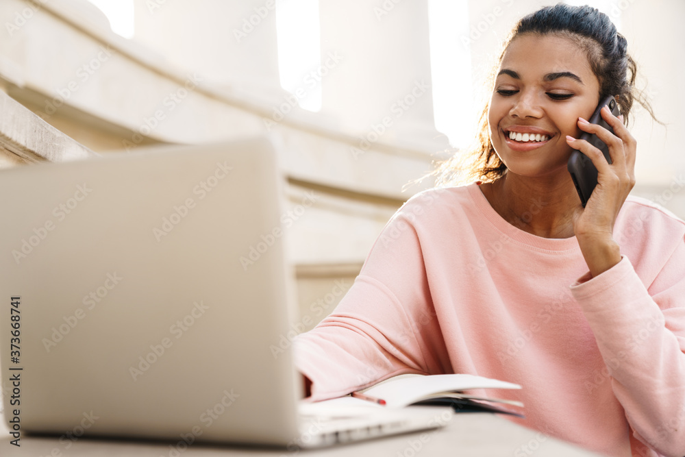 Image of african american student girl doing homework with laptop Image of african american student girl doing homework with laptop