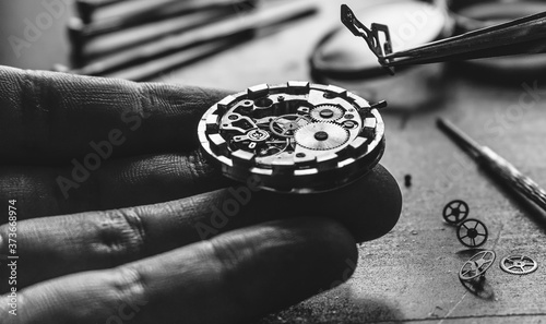 Watchmaker is repearing mechanical wrist watch