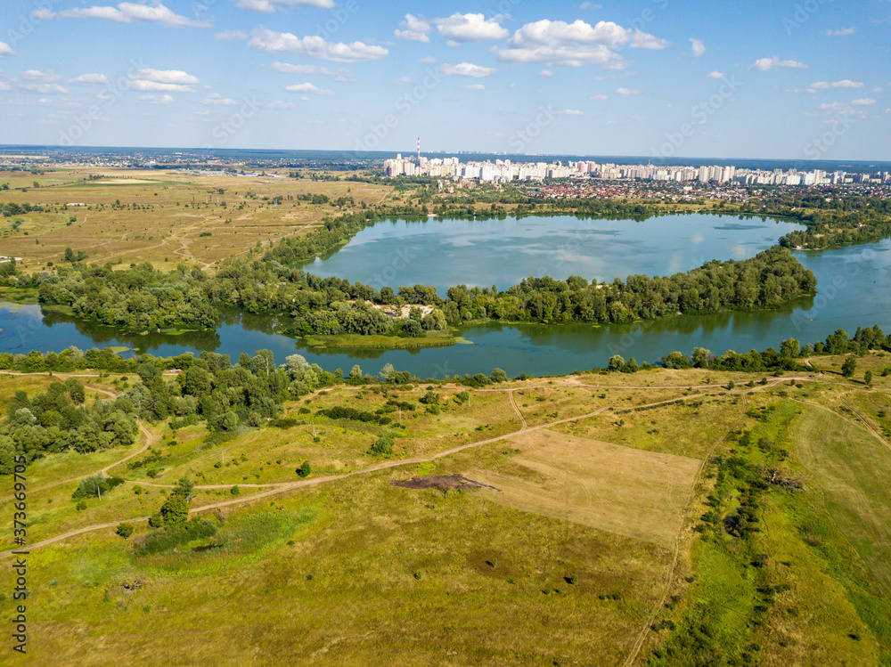 Aerial drone view. Green meadows by the river.