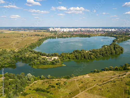 Panoramic view of the Dnieper river in Kiev. Sunny clear day. Aerial drone view.