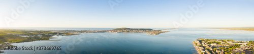 Aerial panoramic of the Thau lagoon and Mont-Saint-Clair from Balaruc, in Hérault in Occitania, France