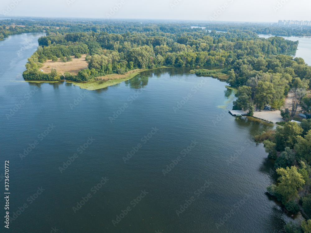 Fototapeta premium Aerial drone view. Green bank of the Dnieper river on a summer sunny day.