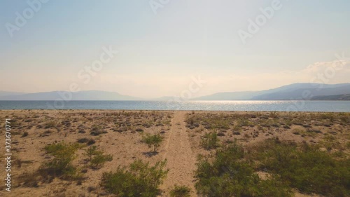 4K aerial drone clip going forward over a dirt track over the beach near Strymonas river in Macedonia, Greece
