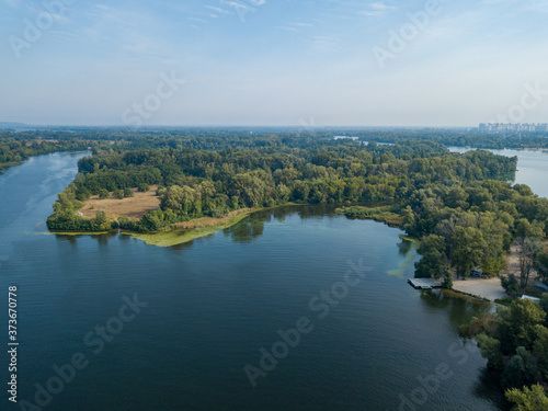 Aerial drone view. Green bank of the Dnieper river on a summer sunny day. © Sergey
