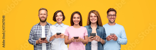 Cheerful young people with smartphones in hands