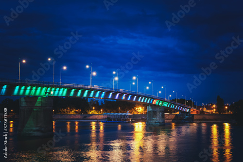 Rainbow bridge by night on Danube river between the Petrovaradin and city of Novi Sad in Serbia at night