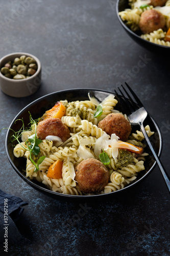Pasta with meatballs and homemade parsley pesto sauce. Copy space.