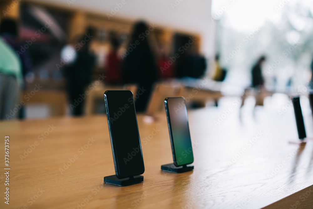 Cupertino , California / USA - November 17, 2018, Apple Park Visitor Center. Modern smartphone with big screen, different models of Iphone, soft focus