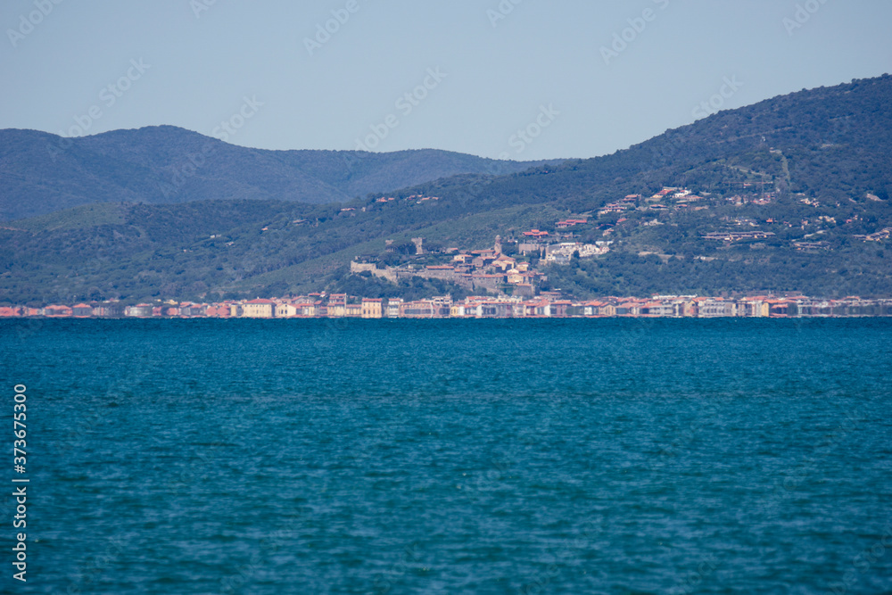 Italy Tuscany Maremma, on the beach towards Bocca di Ombrone, view of the coast line, in the background Marina di Grosseto and Castiglione della Pescaia