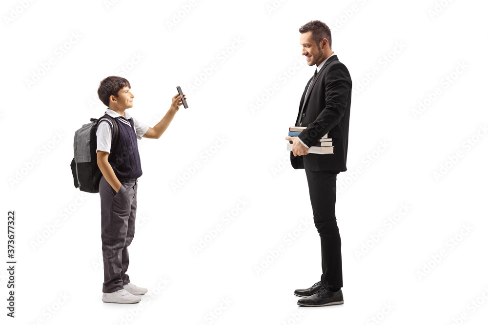 Schoolboy showing a smartphone to a man holding books face masks Schoolboy showing a smartphone to a man holding books face masks