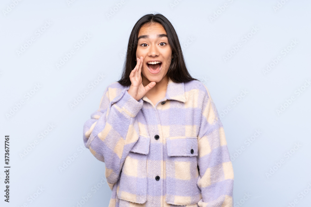 Young Indian woman isolated on blue background with surprise and shocked facial expression Young Indian woman isolated on blue background with surprise and shocked facial expression