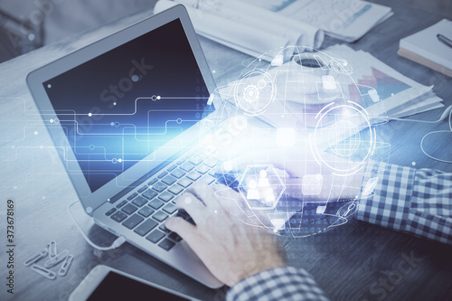 Social network theme hologram with businessman working on computer on background. Concept of world wide web. Double exposure.
