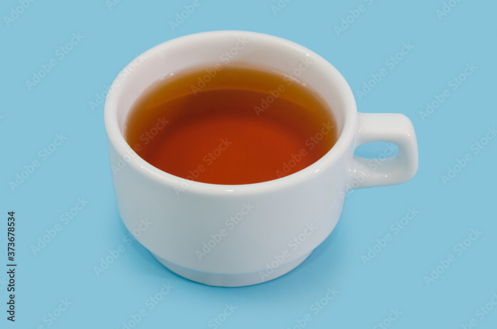 white cup with tea on a blue background. Close-up. white cup with tea on a blue background. Close-up.