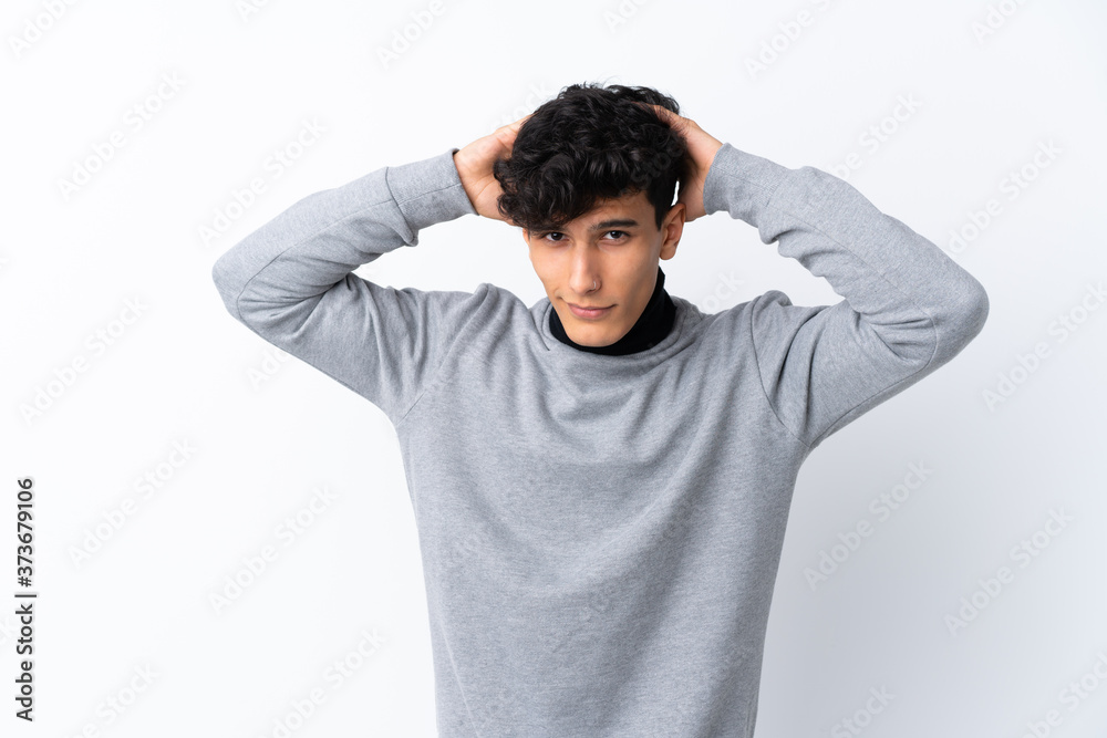 Young Argentinian man over isolated white background frustrated and takes hands on head Young Argentinian man over isolated white background frustrated and takes hands on head