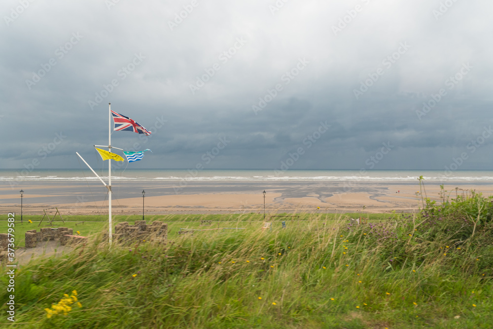 British Union Jack Flag flies on Shoreline British Union Jack Flag flies on Shoreline