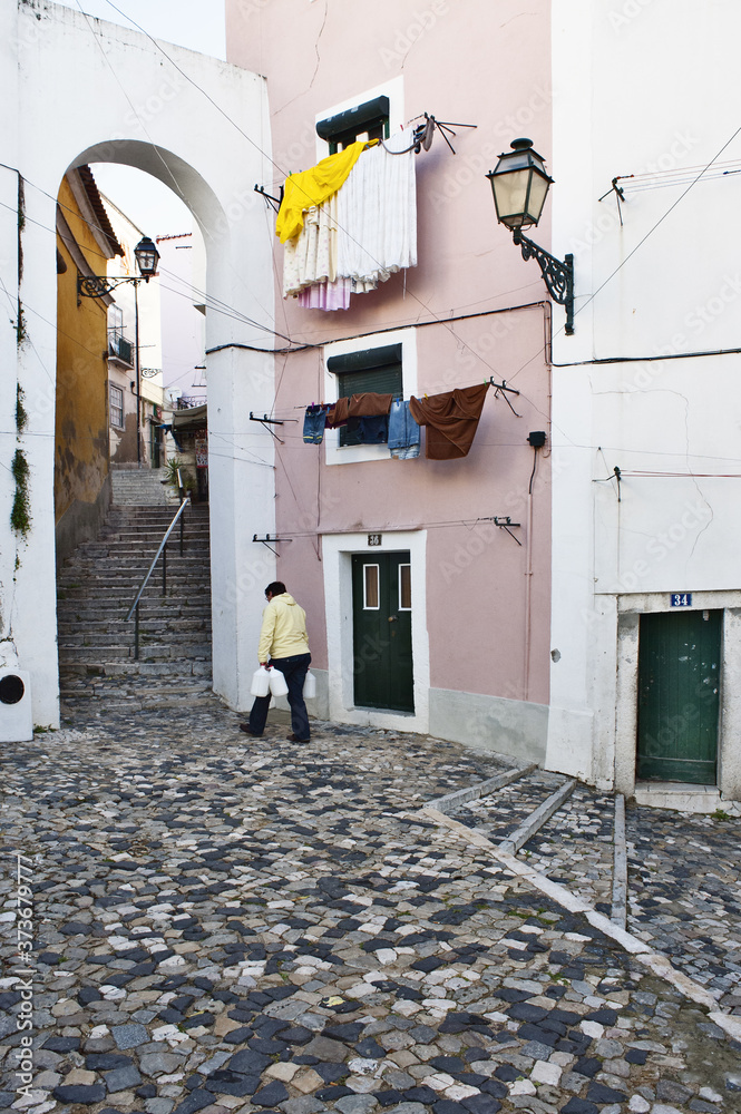 typical and cobbled alley of Alfama in Lisbon