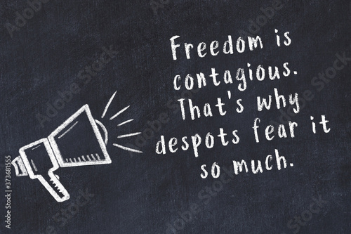 Foto Chalk sketch of loudspeaker on black desk and movitational quote