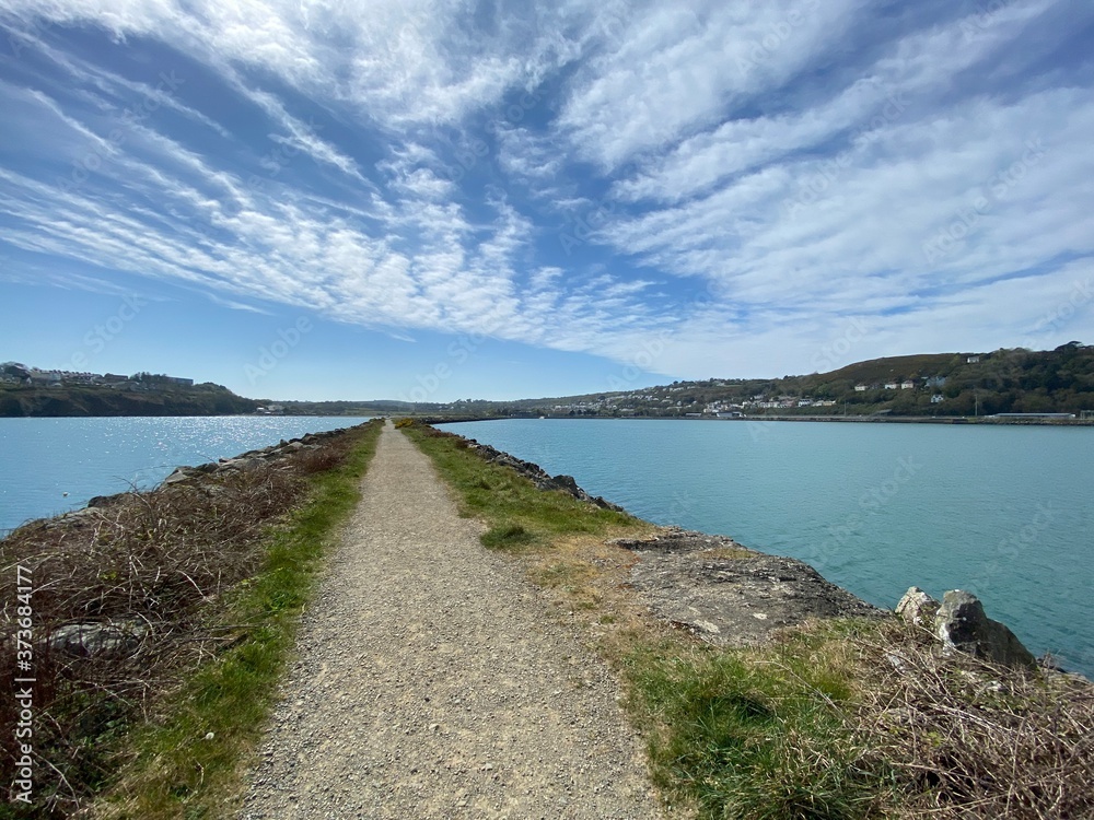 causeway through the sea with blue sky 