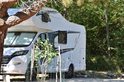 Motorhome standing between plants  photo