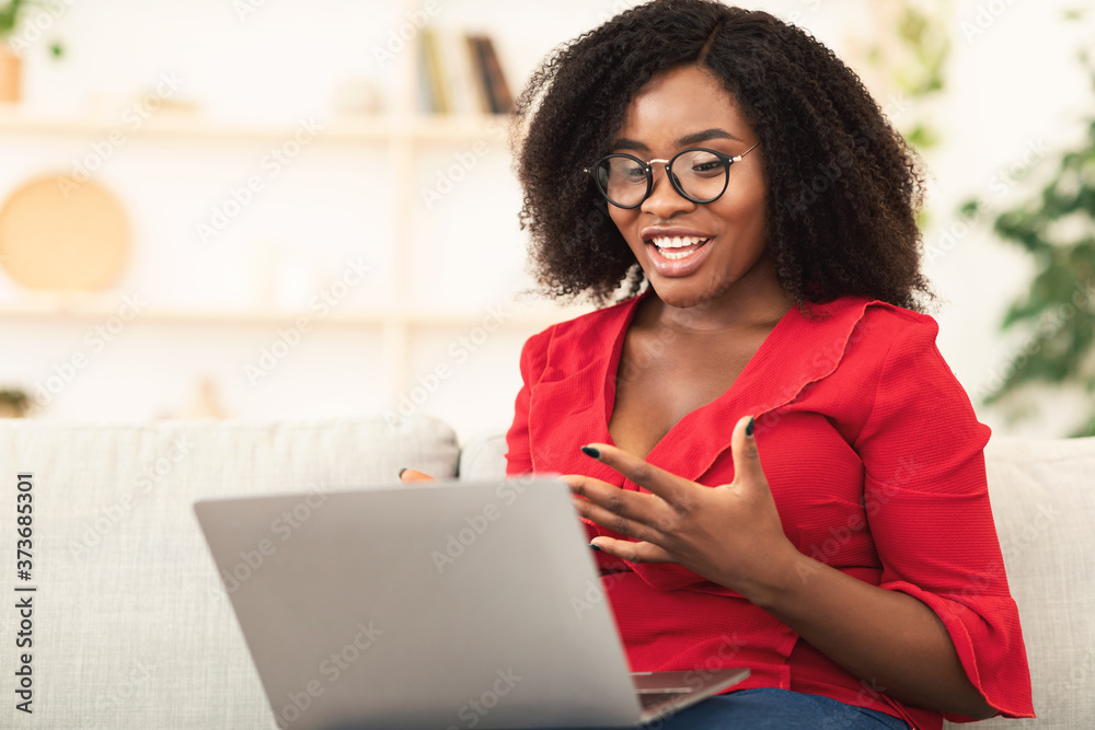 Happy girl using laptop for video call and waving Happy girl using laptop for video call and waving